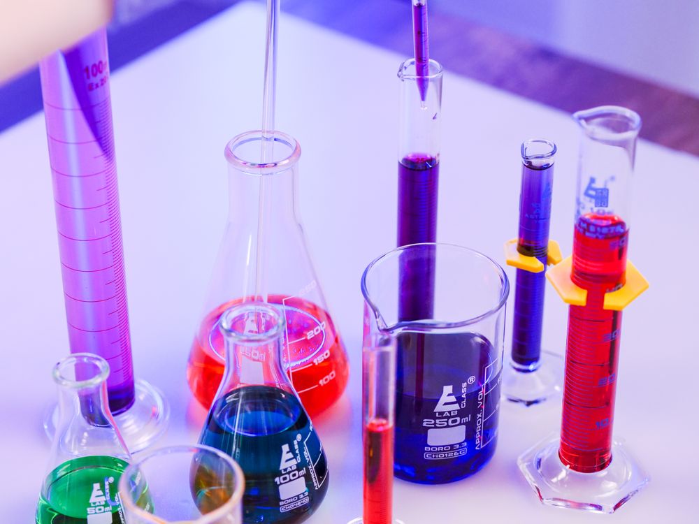 Glass laboratory vessels with coloured chemical solutions